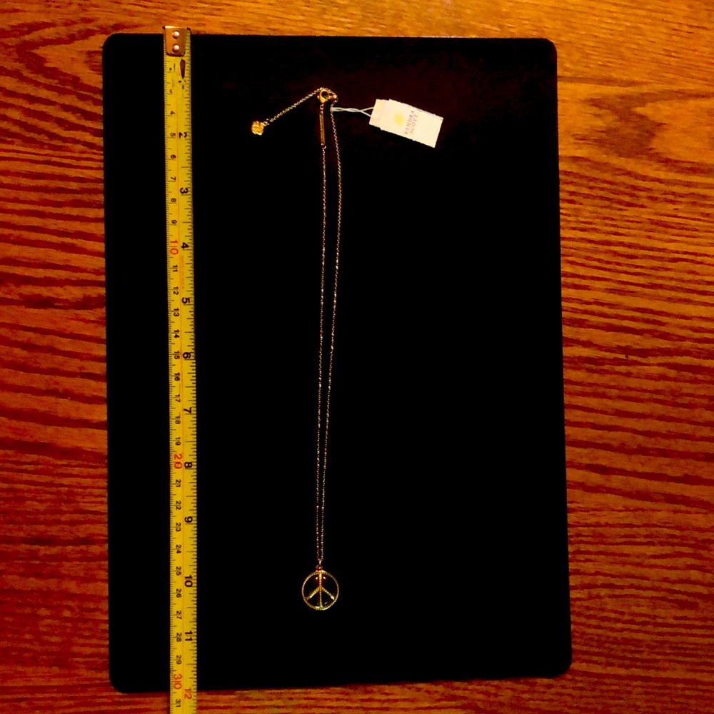 Kendra Scott gold chain and obsidian peace sign pendant